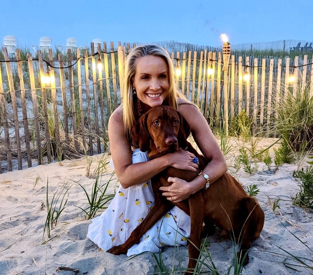 Dana Perino enjoying with her dog on beach.