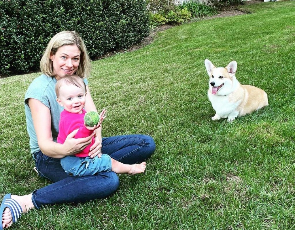 Elise with her baby and her dog.